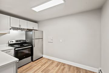 Denver apartment for rent - A kitchen with a stove top oven and a refrigerator.