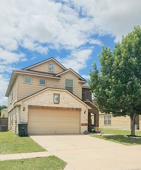 Killeen house for rent - A two-story house with a garage and a tree in front.