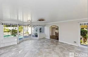 Chino house for rent - A spacious room with a marble floor and a ceiling fan.