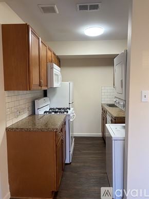 Philadelphia apartment for rent - A kitchen with brown cabinets and a white refrigerator.