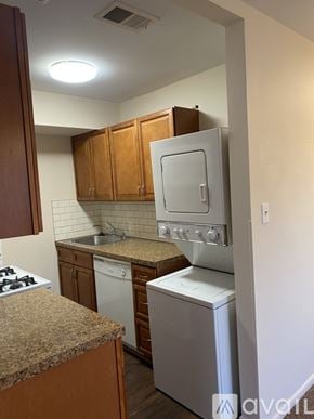 Philadelphia apartment for rent - A kitchen with a white stove top oven and a white dishwasher.