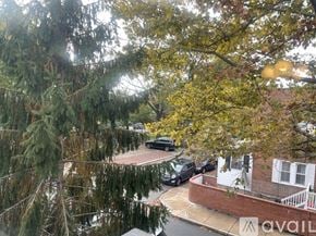 Philadelphia apartment for rent - A tree-lined street with cars parked on the side.