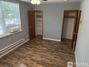 Philadelphia apartment for rent - A room with wooden flooring and a window with blinds.