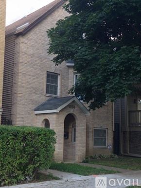 Chicago apartment for rent - A brick house with a window and a door.