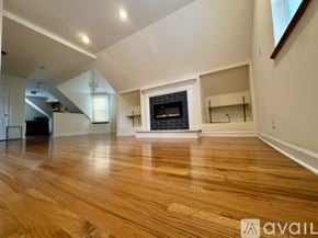 Chicago apartment for rent - A modern living room with a fireplace and wooden floors.