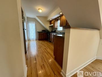 Chicago apartment for rent - A kitchen with wooden cabinets and a refrigerator.