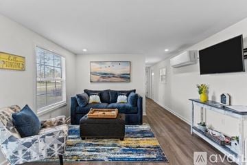 Ocean Isle Beach house for rent - A living room with a blue couch and a rug.