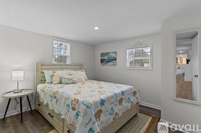 Ocean Isle Beach house for rent - A bedroom with a bed, a small table, and a window.