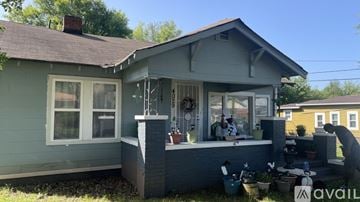 Birmingham house for rent - A house with a grey exterior and a person standing on the porch.