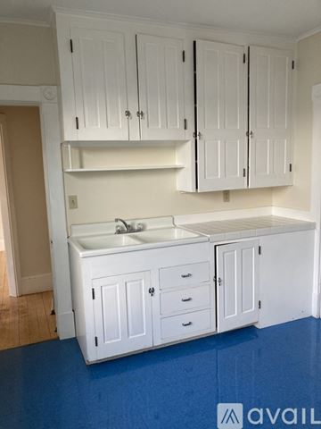 Barre apartment for rent - A kitchen with white cabinets and a sink.