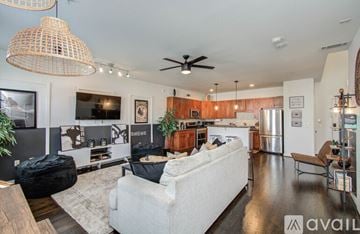 Houston apartment for rent - A living room with a white couch and a wooden table.
