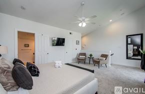 Houston apartment for rent - A bedroom with a large bed and a ceiling fan.