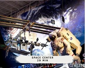 Houston apartment for rent - An astronaut in a space suit is suspended in a space center with a backdrop of a space shuttle.