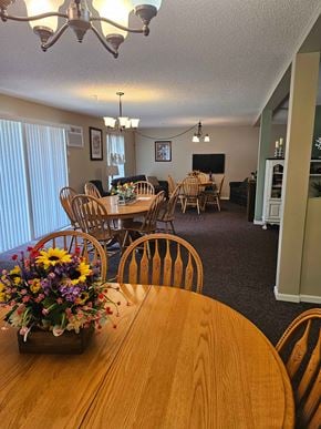Owatonna apartment for rent - A dining room with a wooden table and chairs.