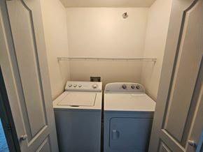 Owatonna apartment for rent - A small laundry room with a washer and dryer.