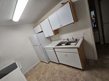 Owatonna apartment for rent - A kitchen with white cabinets and a sink.