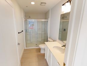 Dartmouth apartment for rent - A white bathroom with a toilet, sink, and shower.