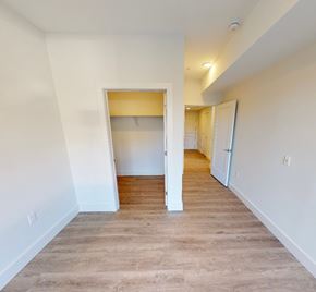 Dartmouth apartment for rent - A room with a white wall and a wooden floor with a doorway leading to another room.