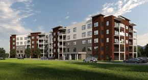 Dartmouth apartment for rent - A modern apartment complex with multiple buildings and cars parked in front.