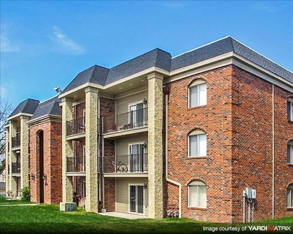 Lincoln apartment for rent - a brick apartment building with balconies and grass
