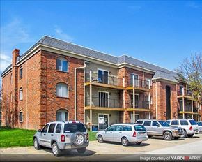 Lincoln apartment for rent - a brick apartment building with cars parked in a parking lot