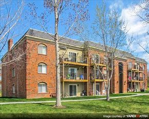 Lincoln apartment for rent - a large brick building with two trees in front of it