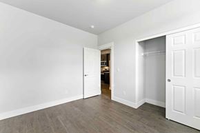 Bend apartment for rent - A room with white walls and a wooden floor.