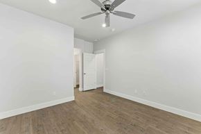 Bend apartment for rent - A room with a ceiling fan and wooden flooring.