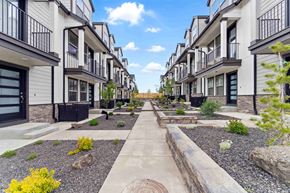 Bend apartment for rent - A row of modern townhouses with a gravel pathway in the foreground.