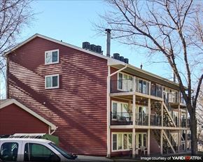 Council Bluffs apartment for rent - a red house with a car parked in front of it