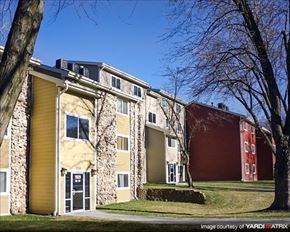 Council Bluffs apartment for rent - a row of yellow and red apartment buildings with trees