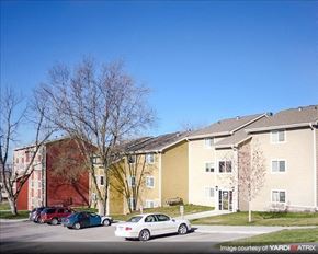Council Bluffs apartment for rent - a row of apartment buildings with cars parked in front