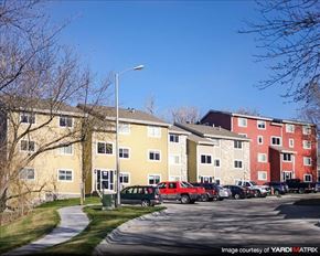 Council Bluffs apartment for rent - a row of apartment buildings with cars parked in front of them