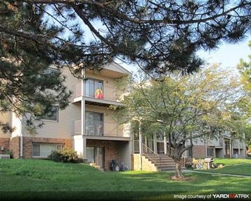 Lincoln apartment for rent - an apartment building with a yard and trees