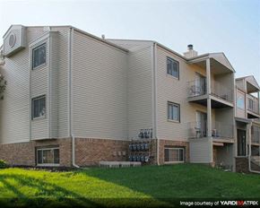 Lincoln apartment for rent - a large apartment building with a yard in front of it
