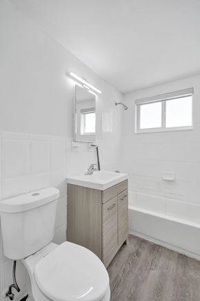 Bay Harbor apartment for rent - A white toilet sits next to a sink in a small bathroom.