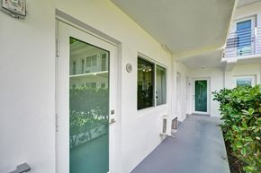 Bay Harbor apartment for rent - A white building with a glass door and a window.