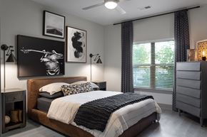 Overland Park apartment for rent - A bedroom with a large bed and a painting on the wall.