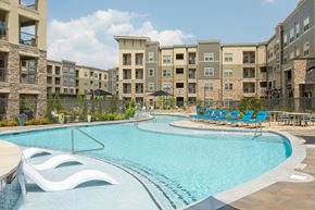 Overland Park apartment for rent - A swimming pool in front of apartment buildings.