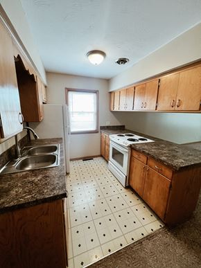 Lincoln apartment for rent - an empty kitchen with a sink stove and refrigerator