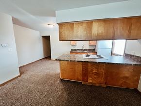 Lincoln apartment for rent - an empty kitchen with wooden cabinets and a counter top