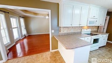 Dothan house for rent - A kitchen with white cabinets and a countertop is available for rent.