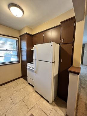 Lincoln apartment for rent - a kitchen with a refrigerator and cabinets and a window