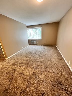 Lincoln apartment for rent - an empty living room with carpet and a window