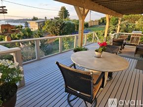 Seattle apartment for rent - A patio with a table and chairs overlooking a view.