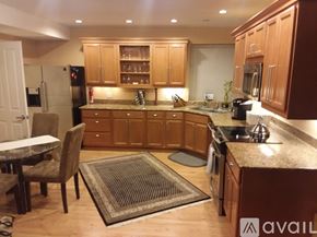 Seattle apartment for rent - A kitchen with wooden cabinets and a granite countertop.