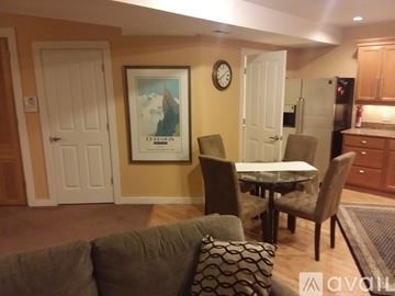 Seattle apartment for rent - A living room with a couch, chairs, and a painting on the wall.