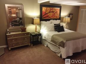 Seattle apartment for rent - A bedroom with a bed, nightstand, and lamp.