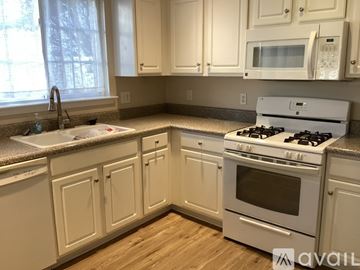 Woodstock house for rent - A kitchen with white cabinets and appliances.
