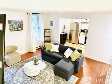 Albany apartment for rent - A living room with a black couch and a coffee table.